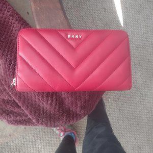 A  DNKY red faux leather vela quilted Chevron large zip around wallet